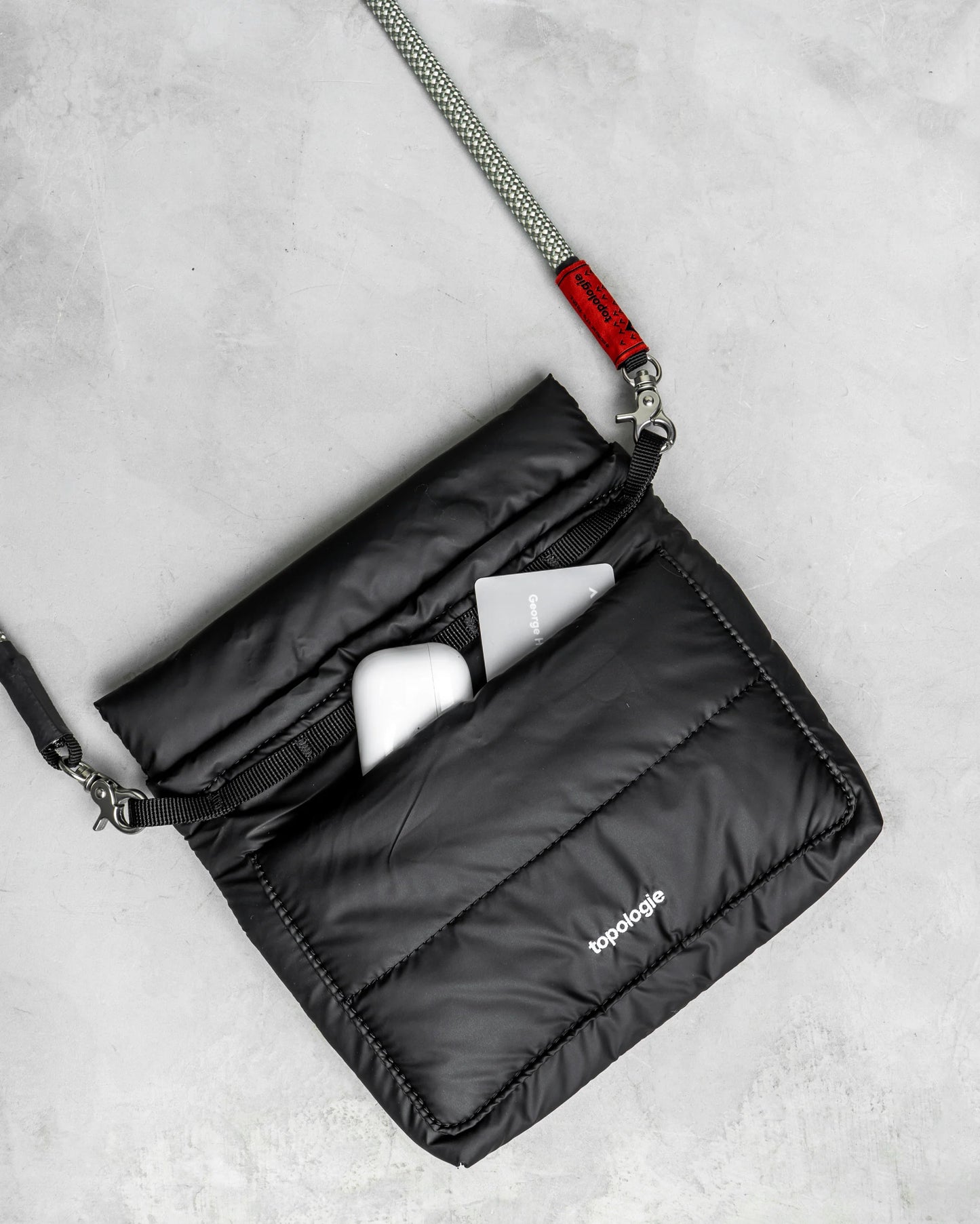 
                  
                    Black Puffer Musette Mini Bag With Future Blue Solid Rope Strap
                  
                
