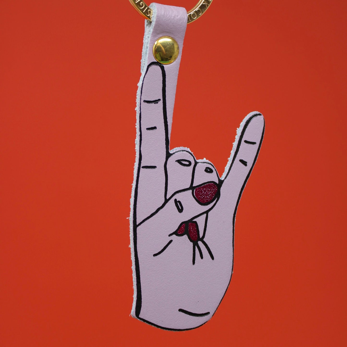 
                  
                    Lila Rock Hand Symbol Schlüsselanhänger
                  
                